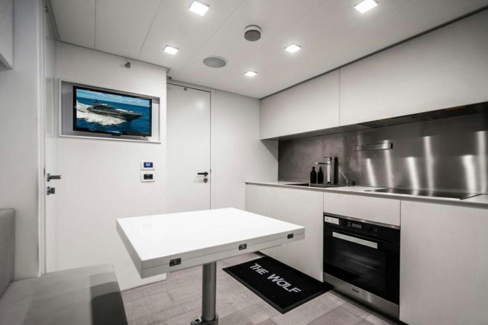 a kitchen with a tv on the wall aboard MARCHELLY Yacht for Sale
