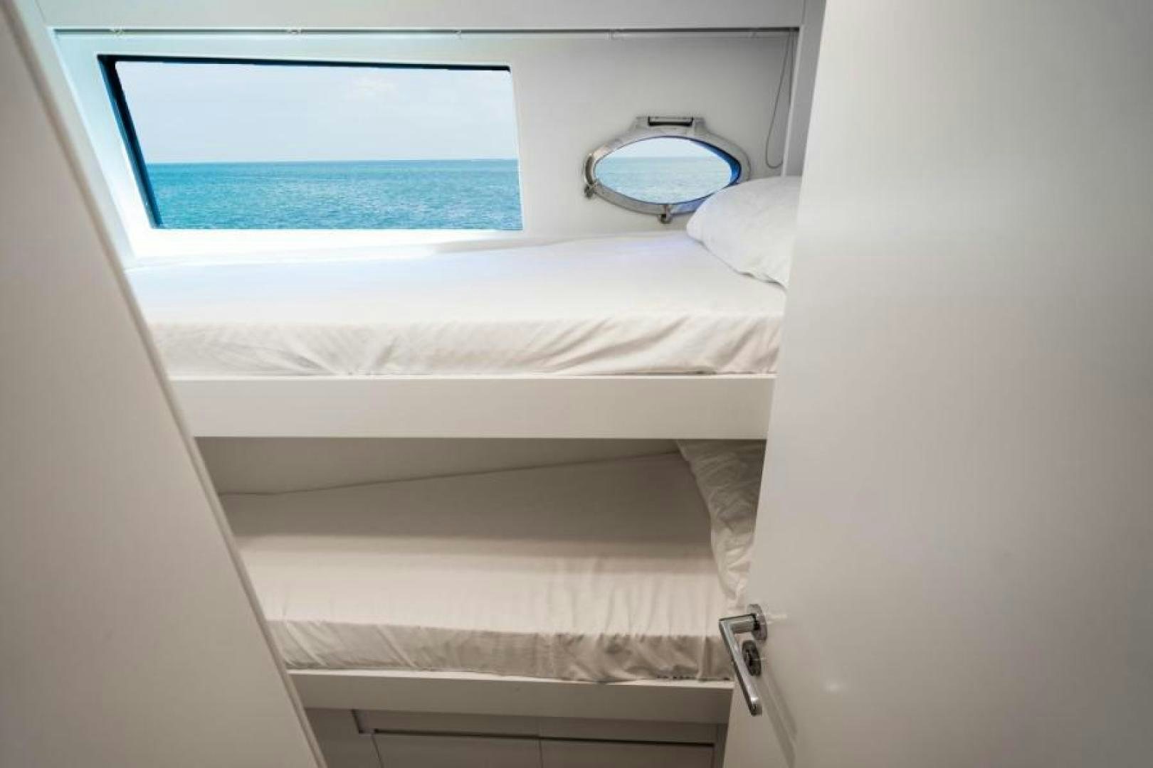 a bed with a window aboard MARCHELLY Yacht for Sale
