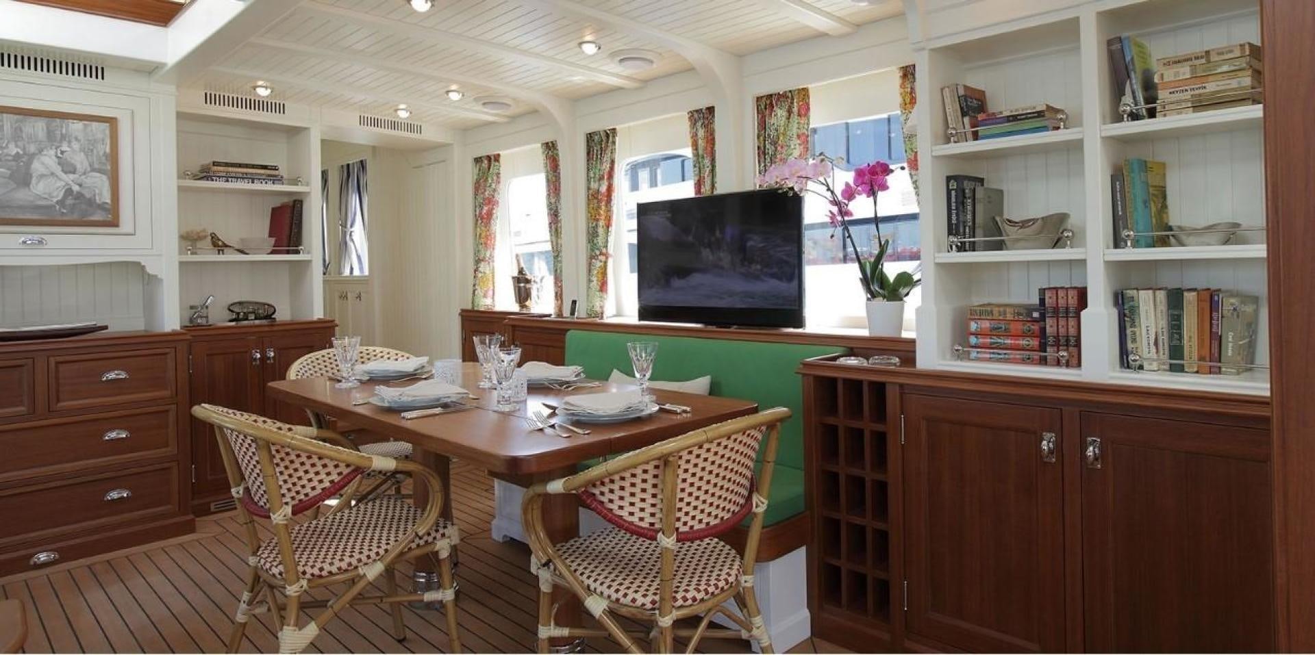 a room with a table and chairs aboard DARWIN Yacht for Sale