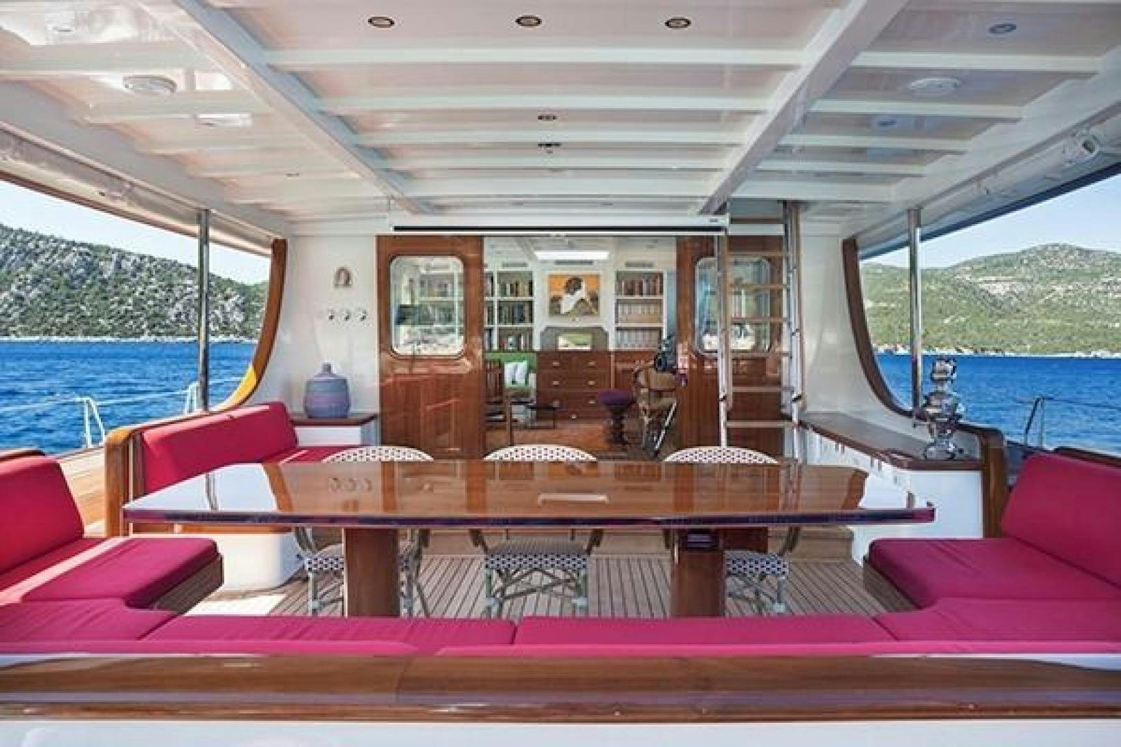 a boat with a table and chairs aboard DARWIN Yacht for Sale