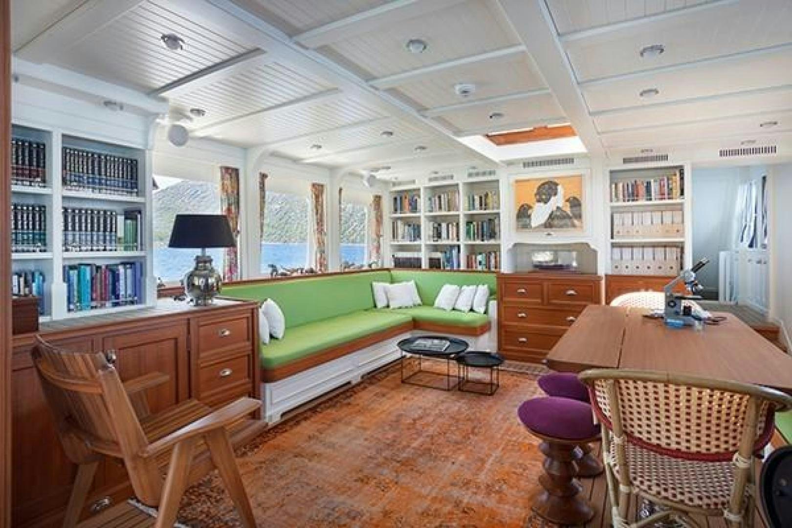 a living room with a couch and a table aboard DARWIN Yacht for Sale