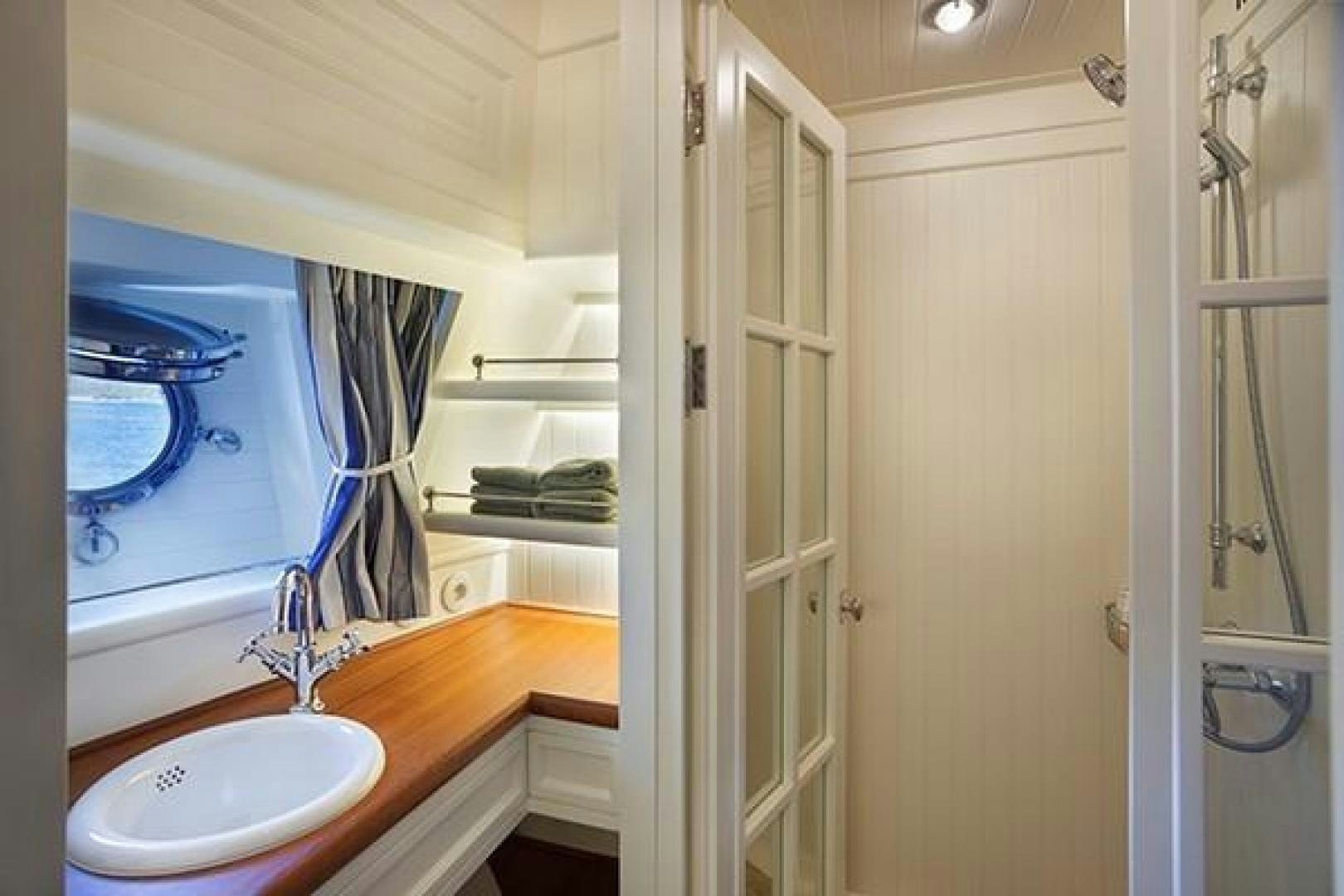 a bathroom with a sink and a mirror aboard DARWIN Yacht for Sale