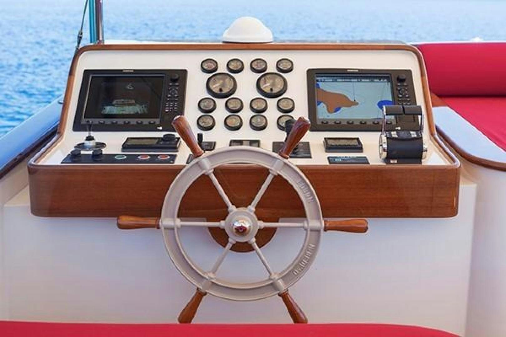 a wooden boat with a steering wheel aboard DARWIN Yacht for Sale