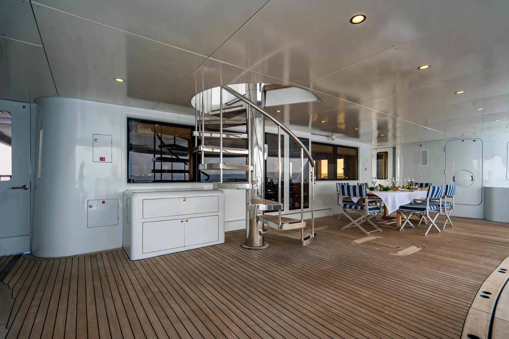 a room with a staircase and a table and chairs aboard MY SPIRIT Yacht for Sale
