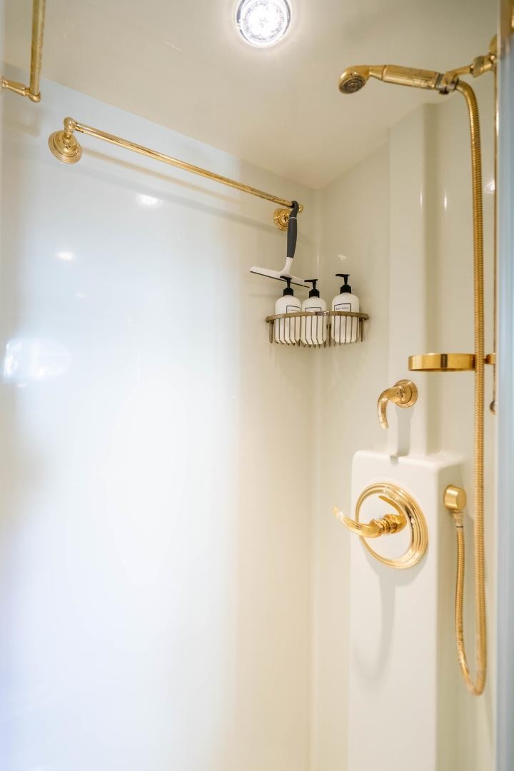 a white door with a gold handle aboard WILD KINGDOM Yacht for Sale