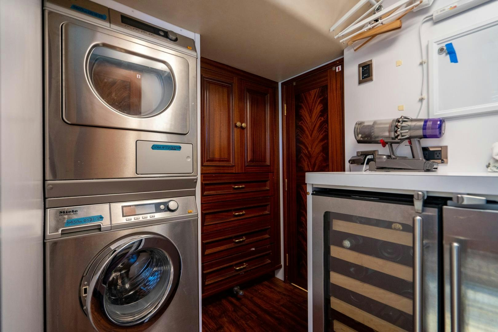 a kitchen with a washing machine and oven aboard WILD KINGDOM Yacht for Sale