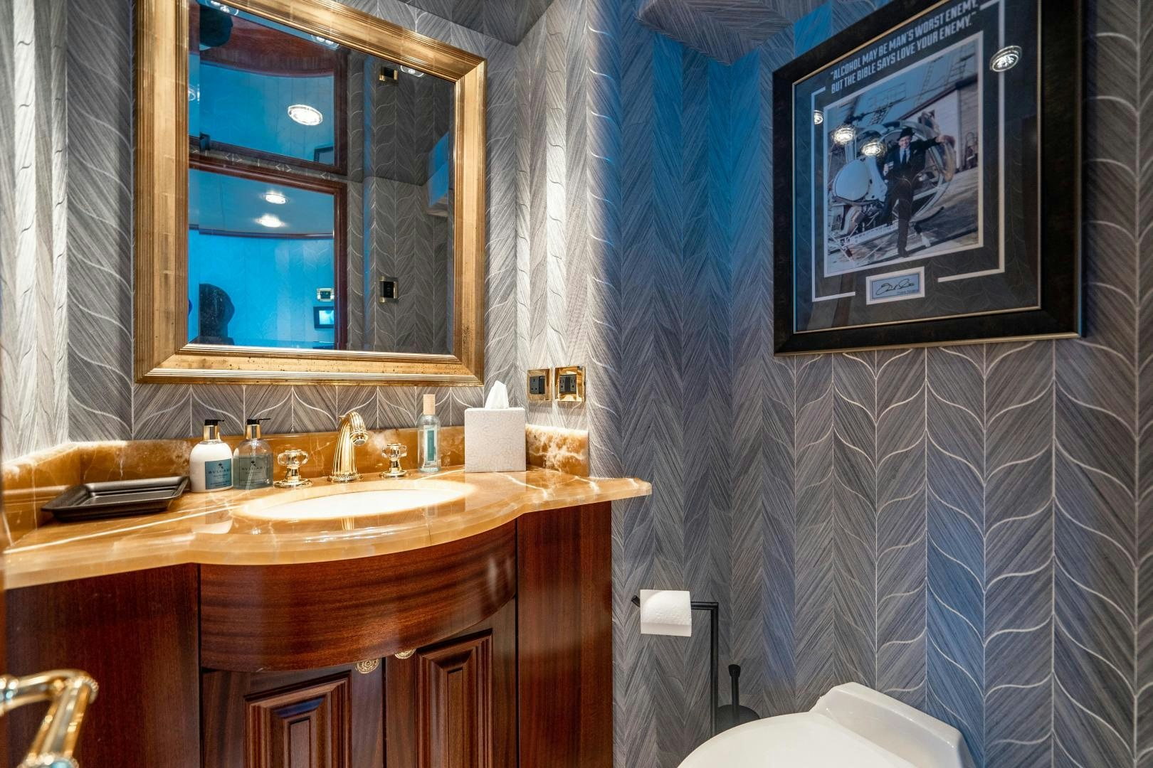 a bathroom with a sink and a mirror aboard WILD KINGDOM Yacht for Sale