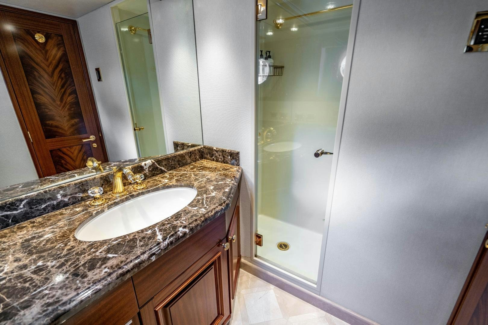 a bathroom with a marble counter top aboard WILD KINGDOM Yacht for Sale