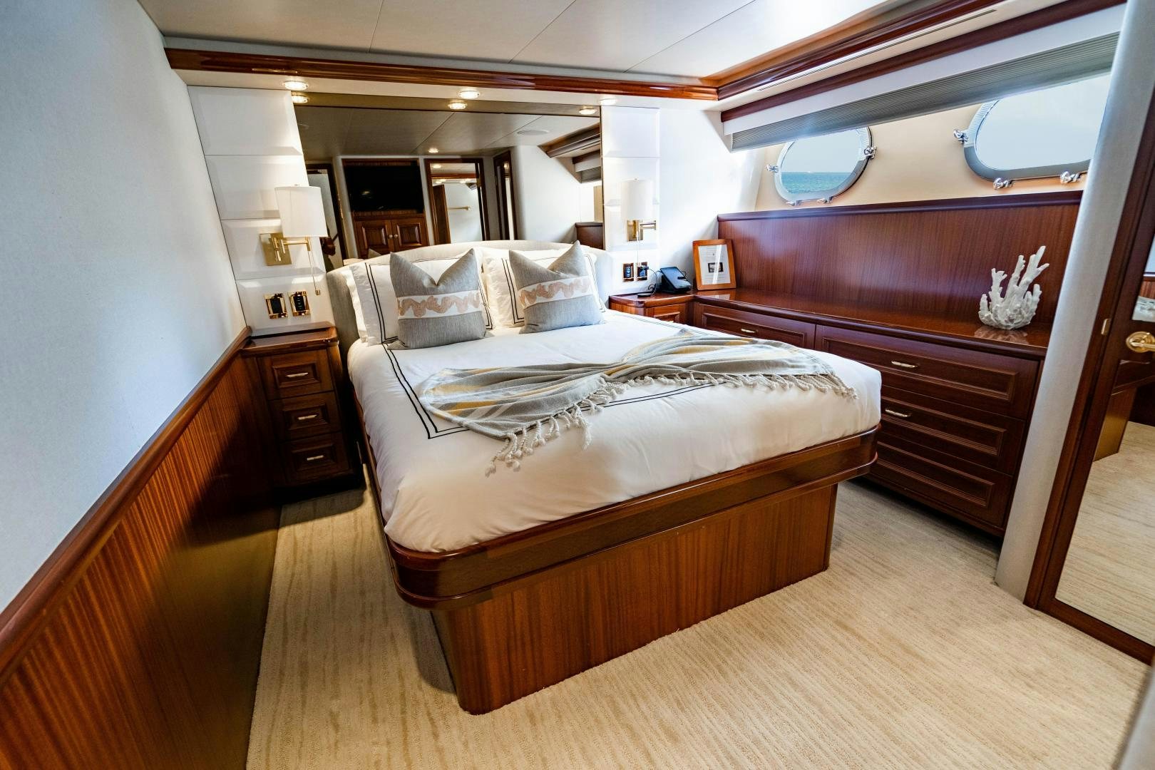 a bedroom with a bed and a dresser aboard WILD KINGDOM Yacht for Sale