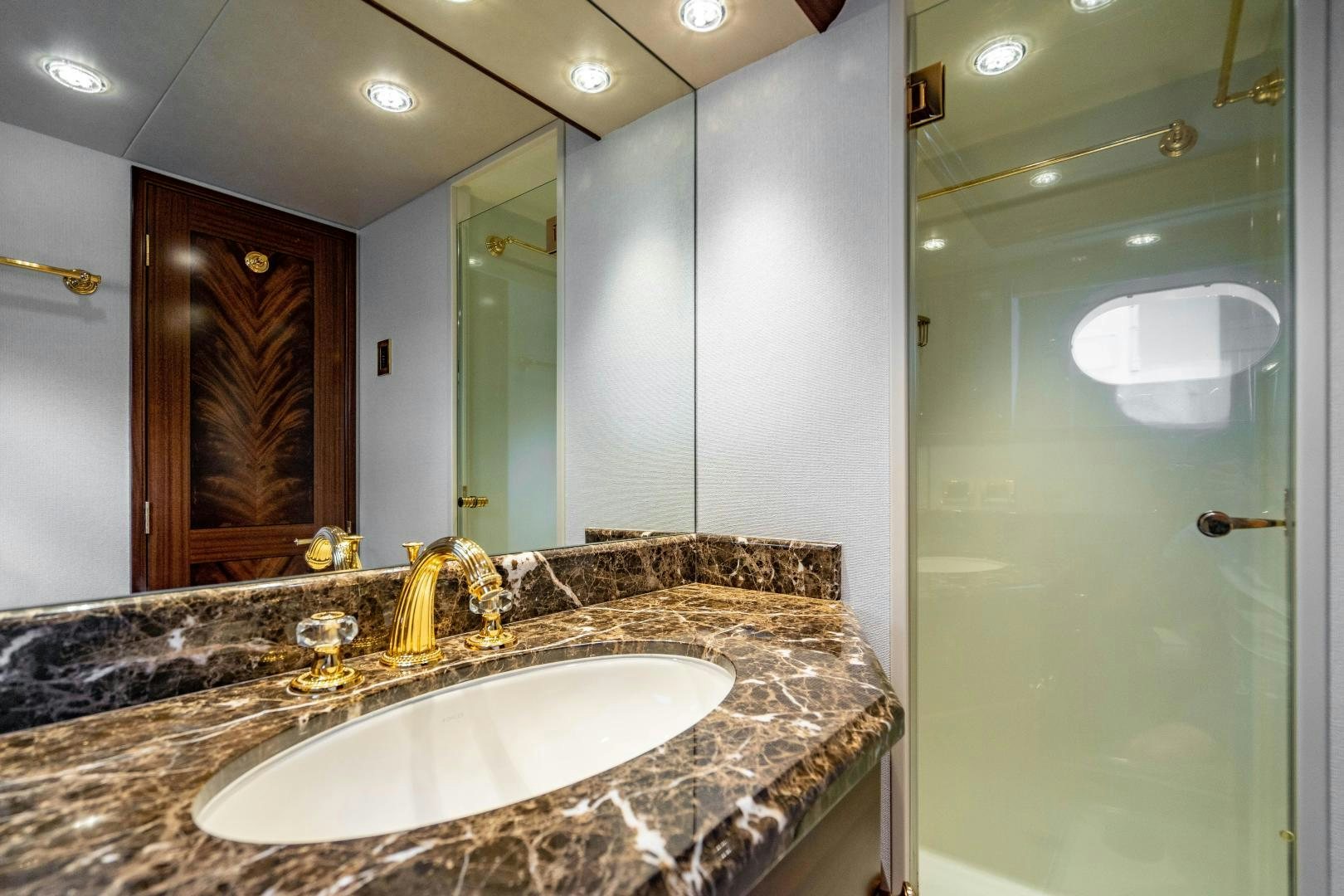 a bathroom with a marble countertop aboard WILD KINGDOM Yacht for Sale