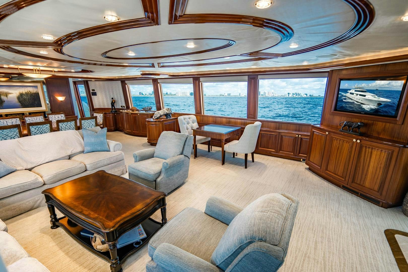 a large living room with a large window aboard WILD KINGDOM Yacht for Sale