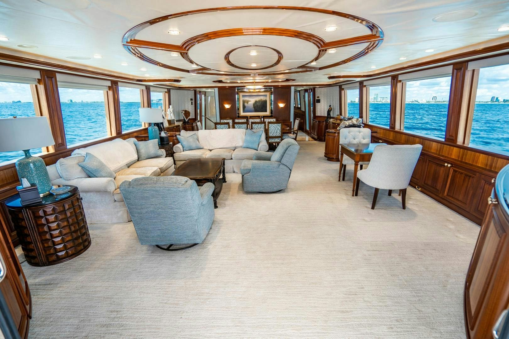a large living room with a large chandelier aboard WILD KINGDOM Yacht for Sale