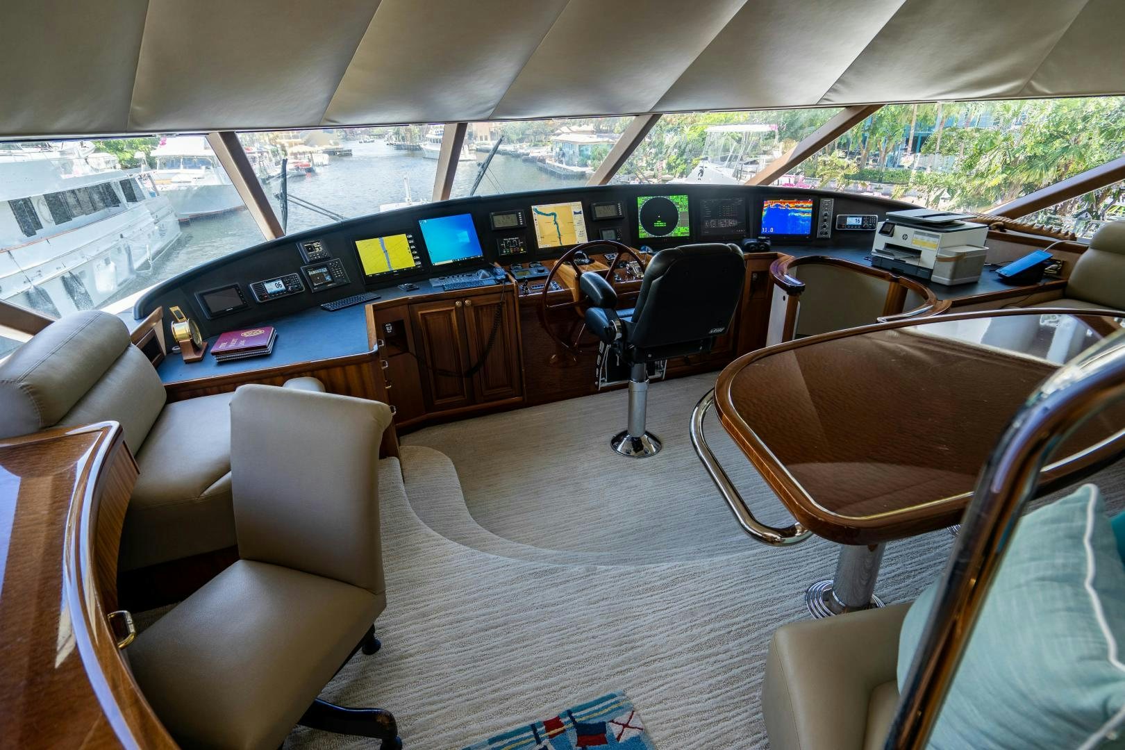 inside of a car with seats and seats and a table with chairs and a large window with a aboard WILD KINGDOM Yacht for Sale