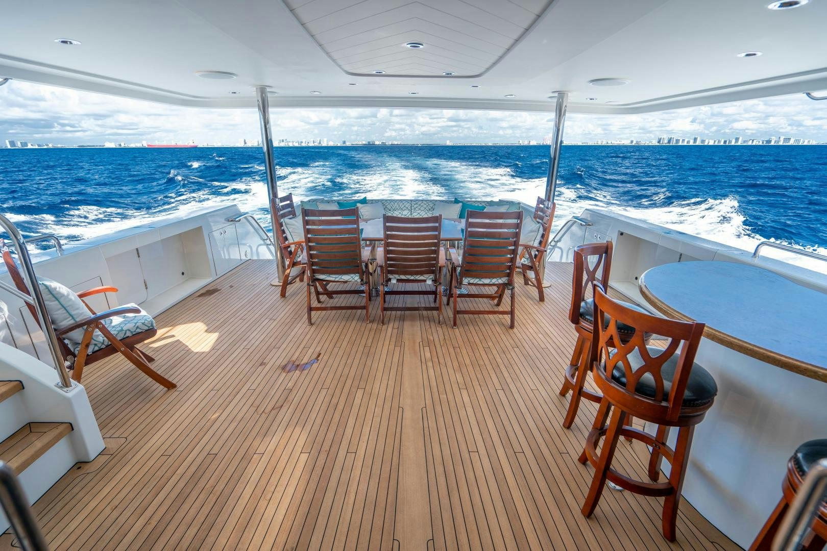 a deck with chairs and tables on it aboard WILD KINGDOM Yacht for Sale