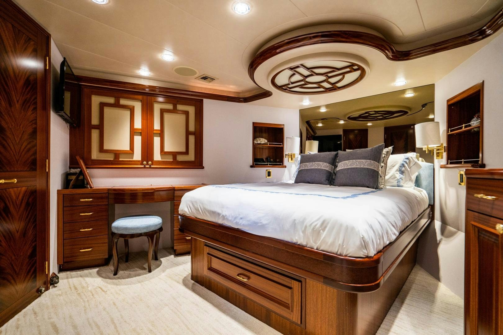 a bedroom with a bed and a desk aboard WILD KINGDOM Yacht for Sale