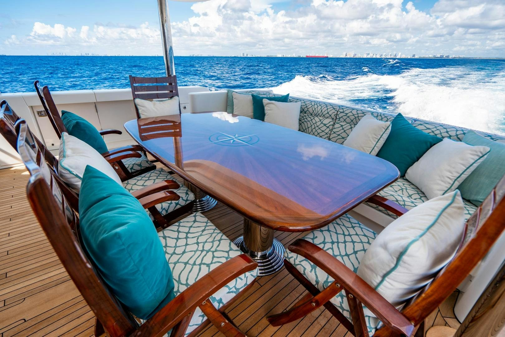 a deck with chairs and a body of water in the background aboard WILD KINGDOM Yacht for Sale