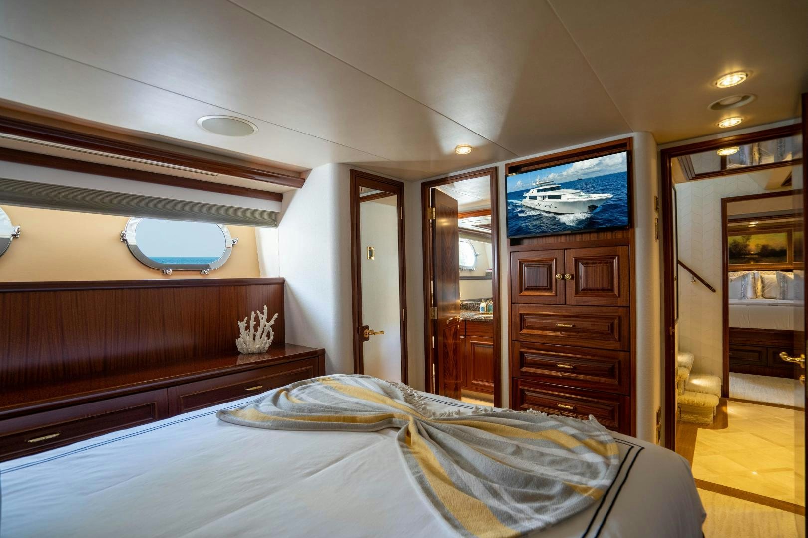 a bedroom with a large tv aboard WILD KINGDOM Yacht for Sale
