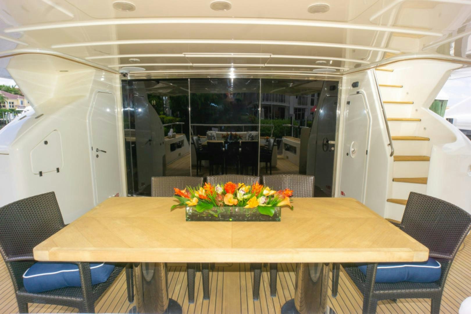 a table with flowers on it aboard ADAR Yacht for Sale