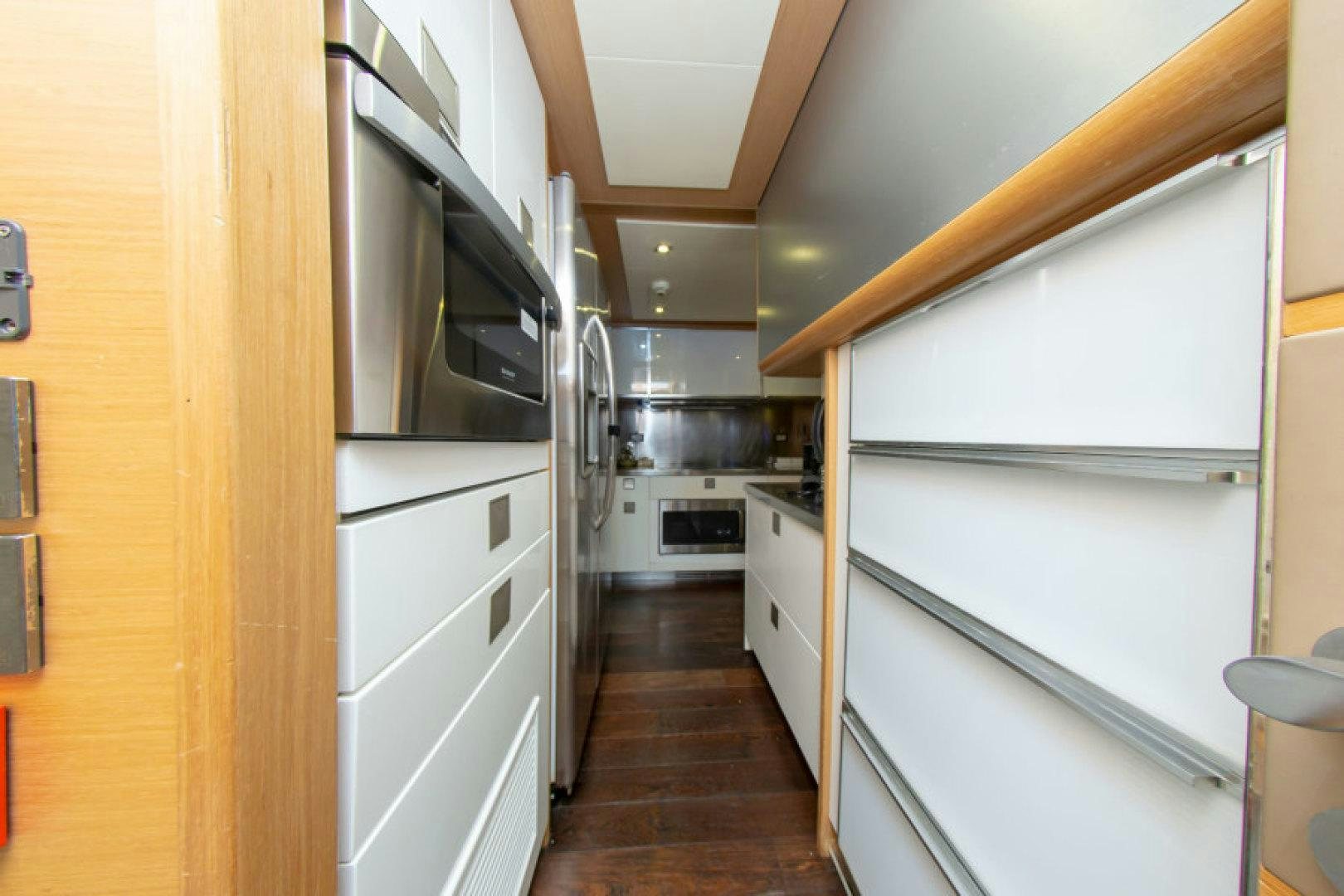 a kitchen with a wood floor aboard ADAR Yacht for Sale