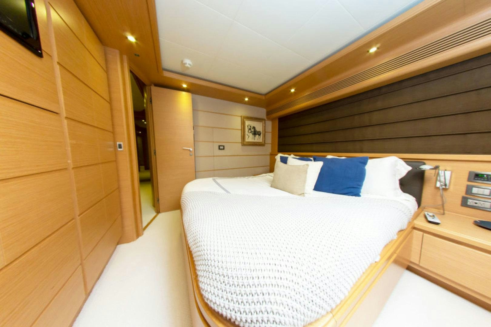a room with a bed and a desk aboard ADAR Yacht for Sale