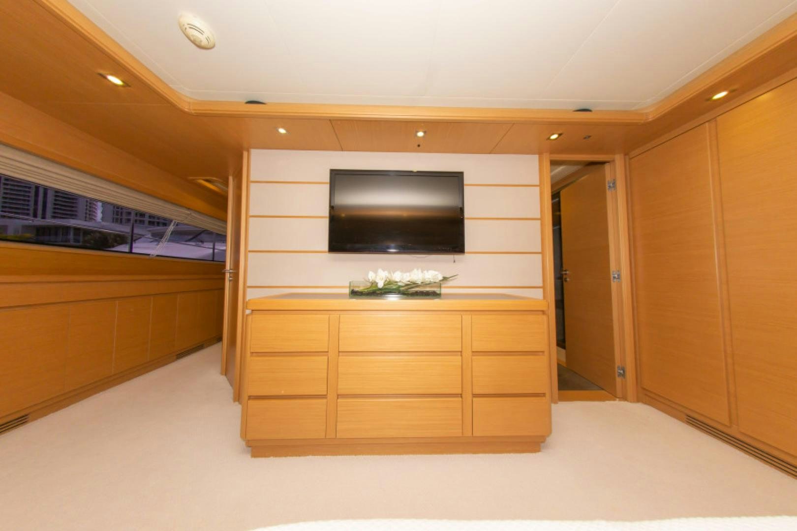 a room with a tv and cabinets aboard ADAR Yacht for Sale