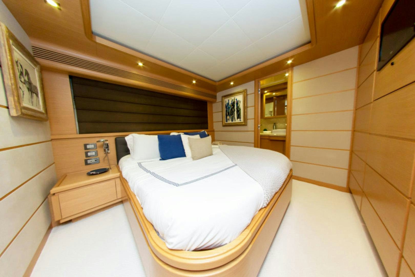 a room with a bed and a mirror aboard ADAR Yacht for Sale