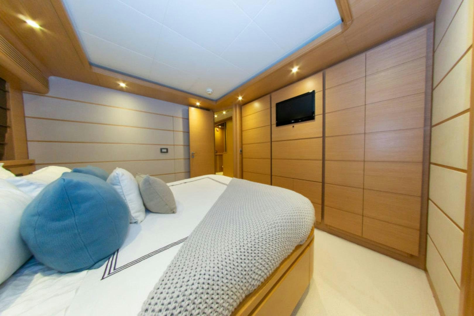 a room with a bed and a mirror aboard ADAR Yacht for Sale