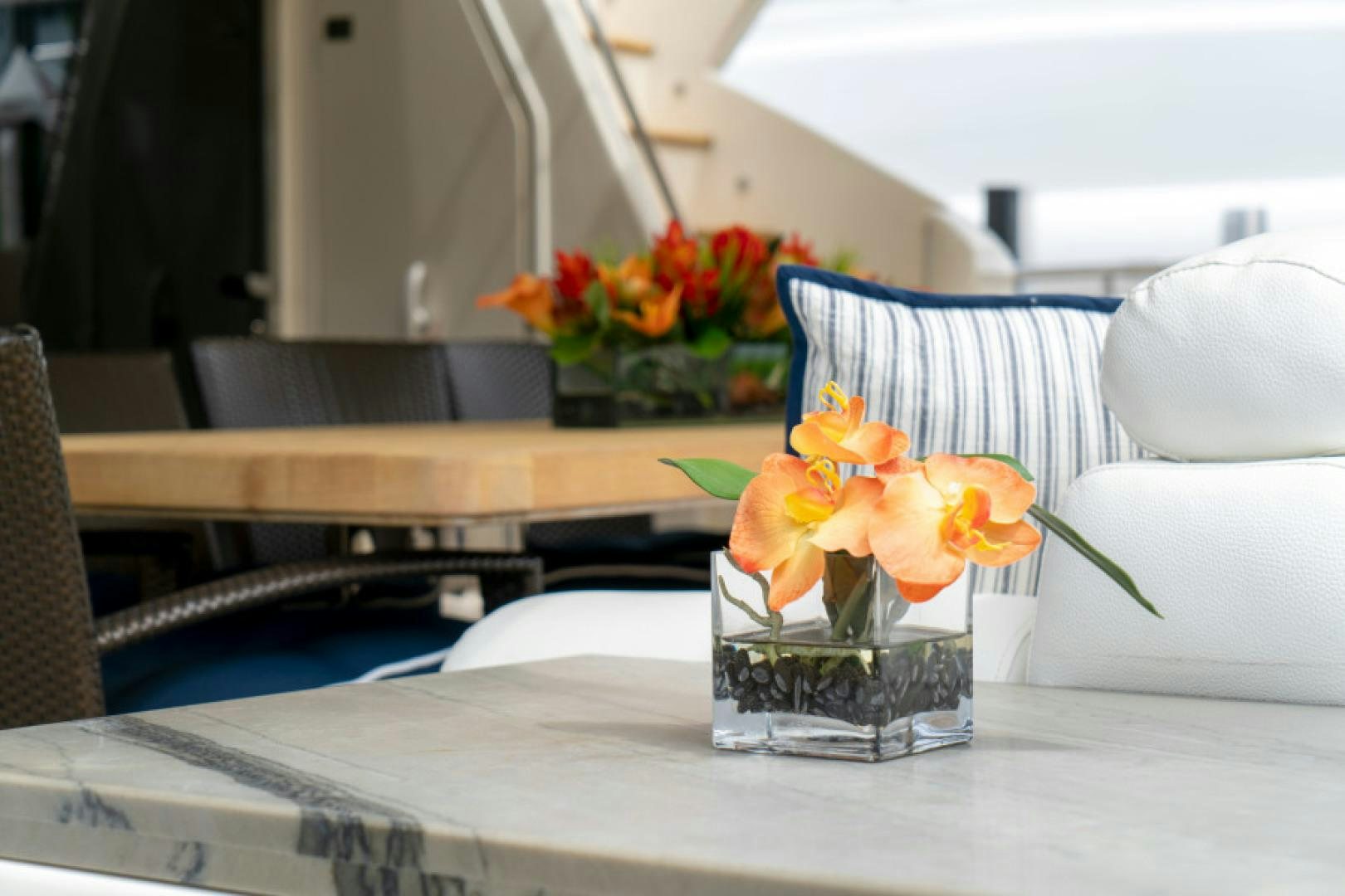 a vase of flowers sits on a table aboard ADAR Yacht for Sale