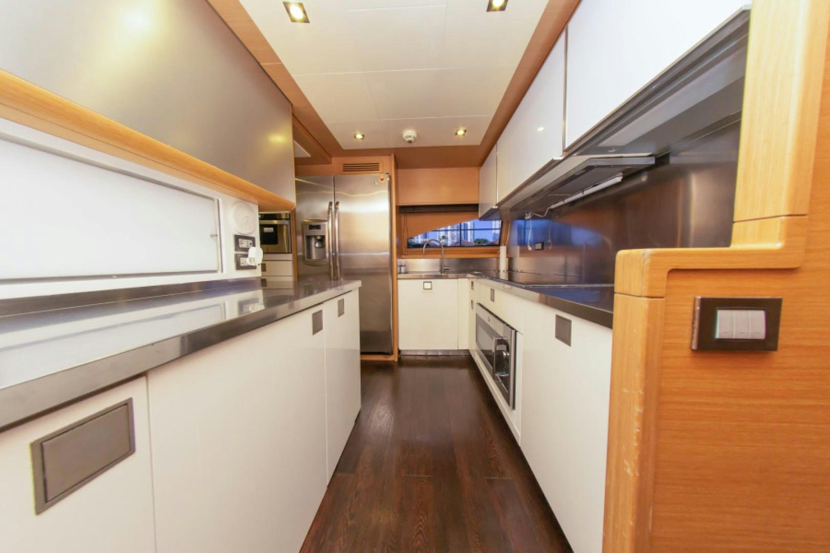 a kitchen with white cabinets aboard ADAR Yacht for Sale
