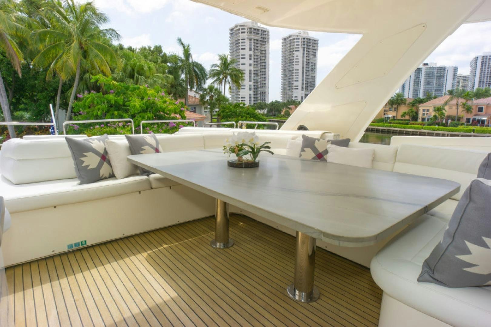 a large white table with chairs on it aboard ADAR Yacht for Sale