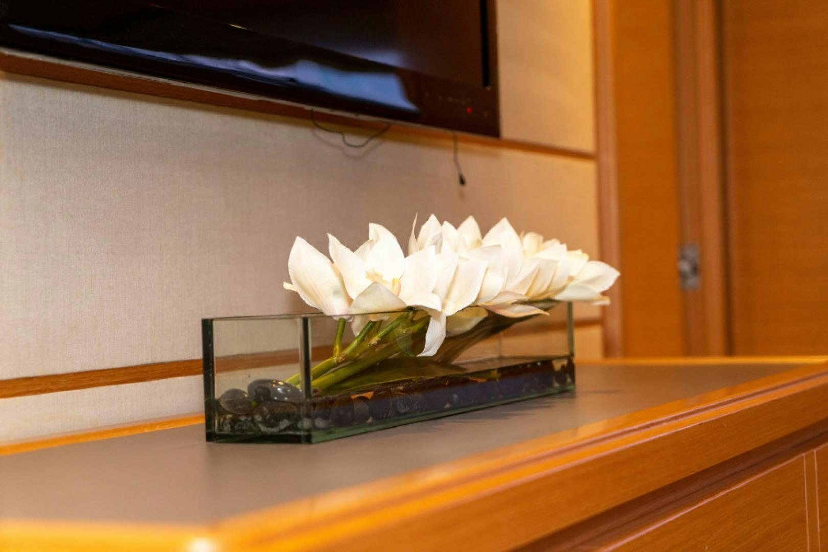 white flowers on a table aboard ADAR Yacht for Sale
