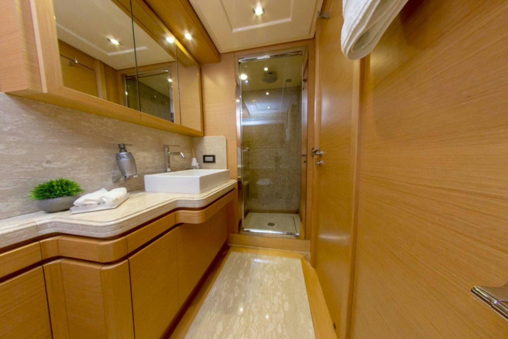 a bathroom with a shower and sinks aboard ADAR Yacht for Sale