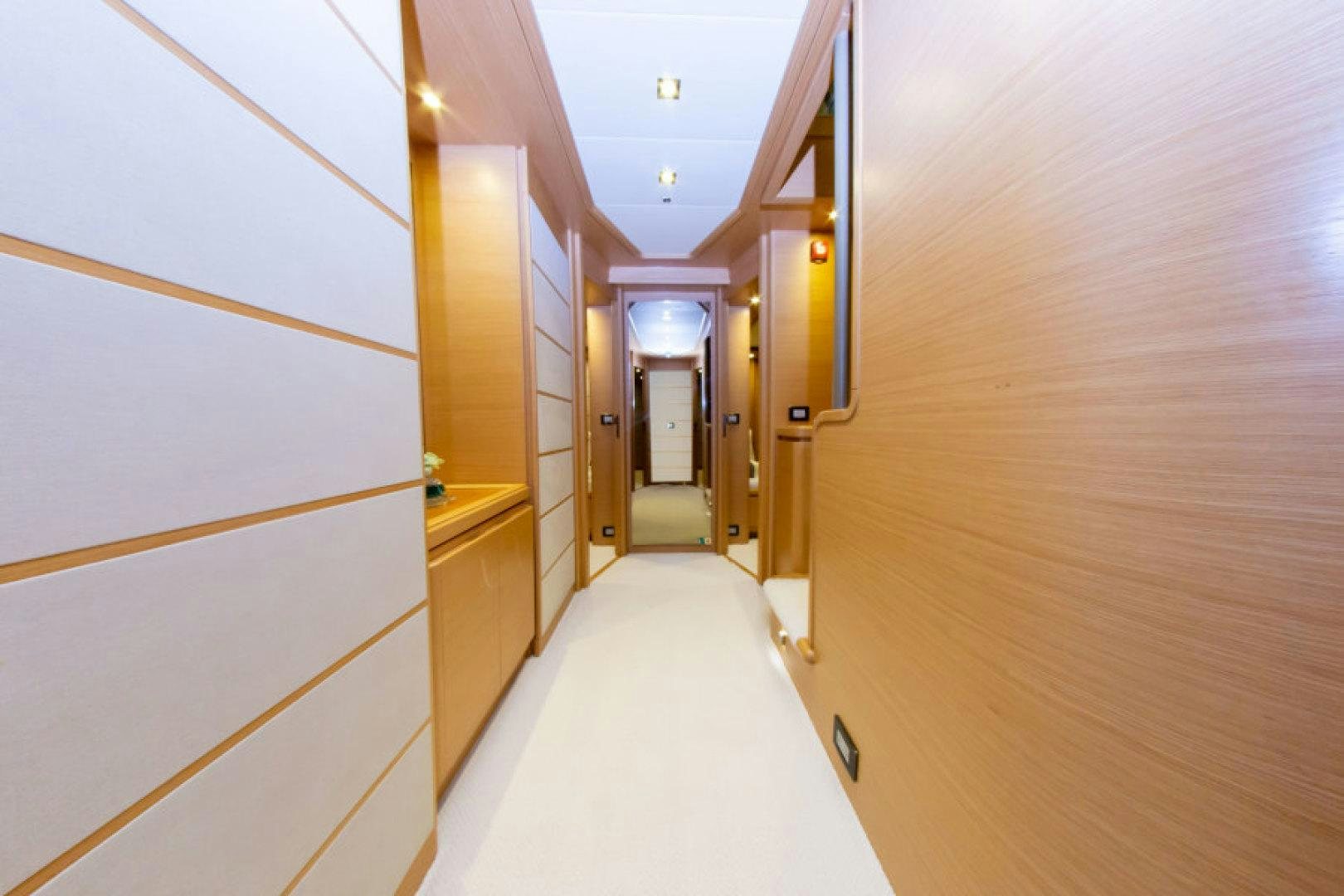 a hallway with a bed and a door aboard ADAR Yacht for Sale