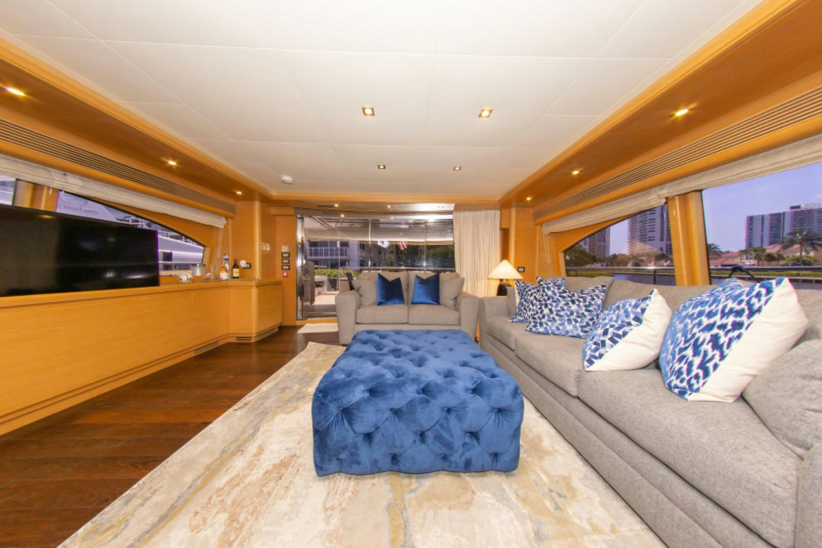 a large living room with a large bed and a large blue rug aboard ADAR Yacht for Sale