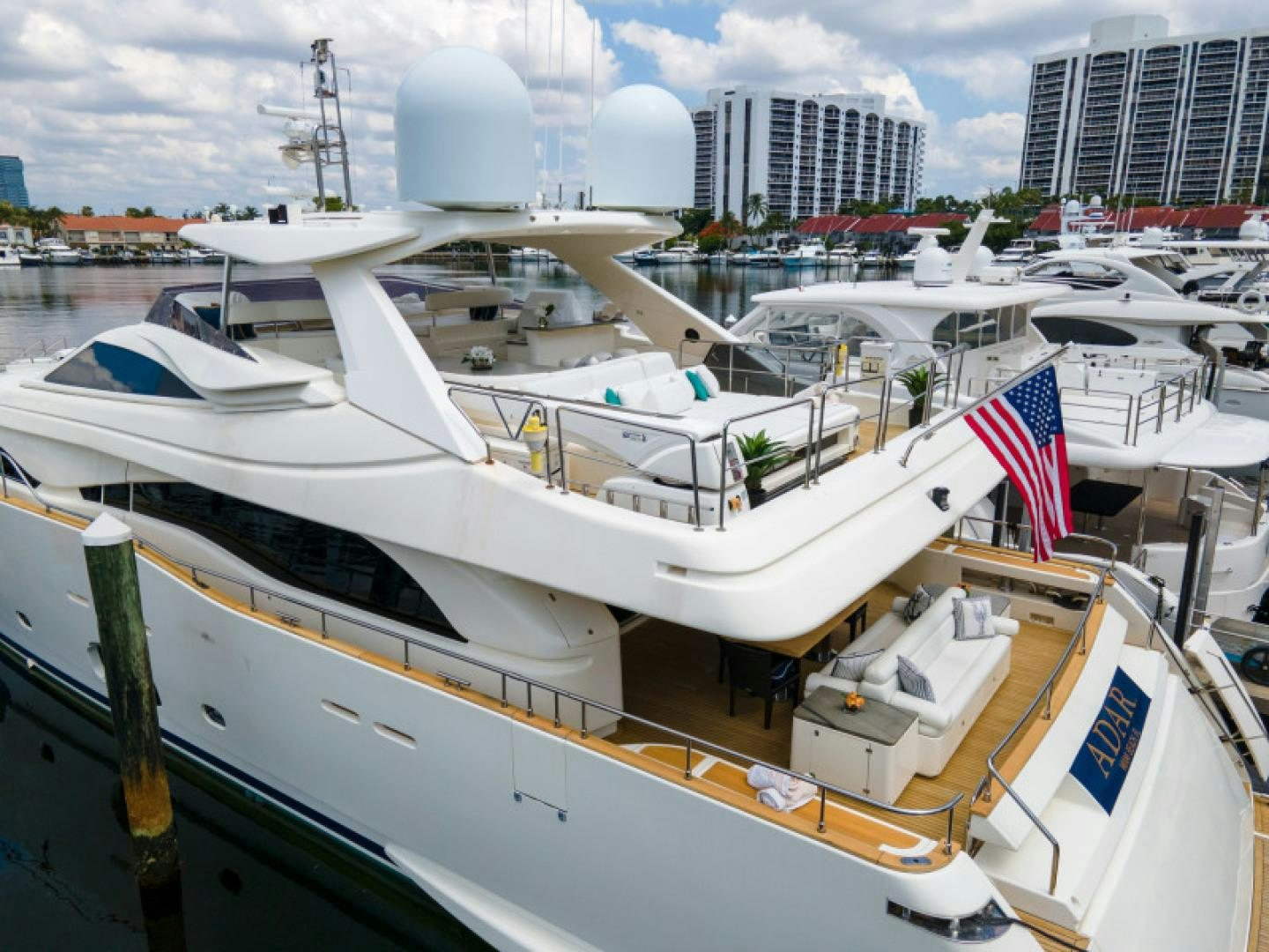 a boat with a flag on the front aboard ADAR Yacht for Sale