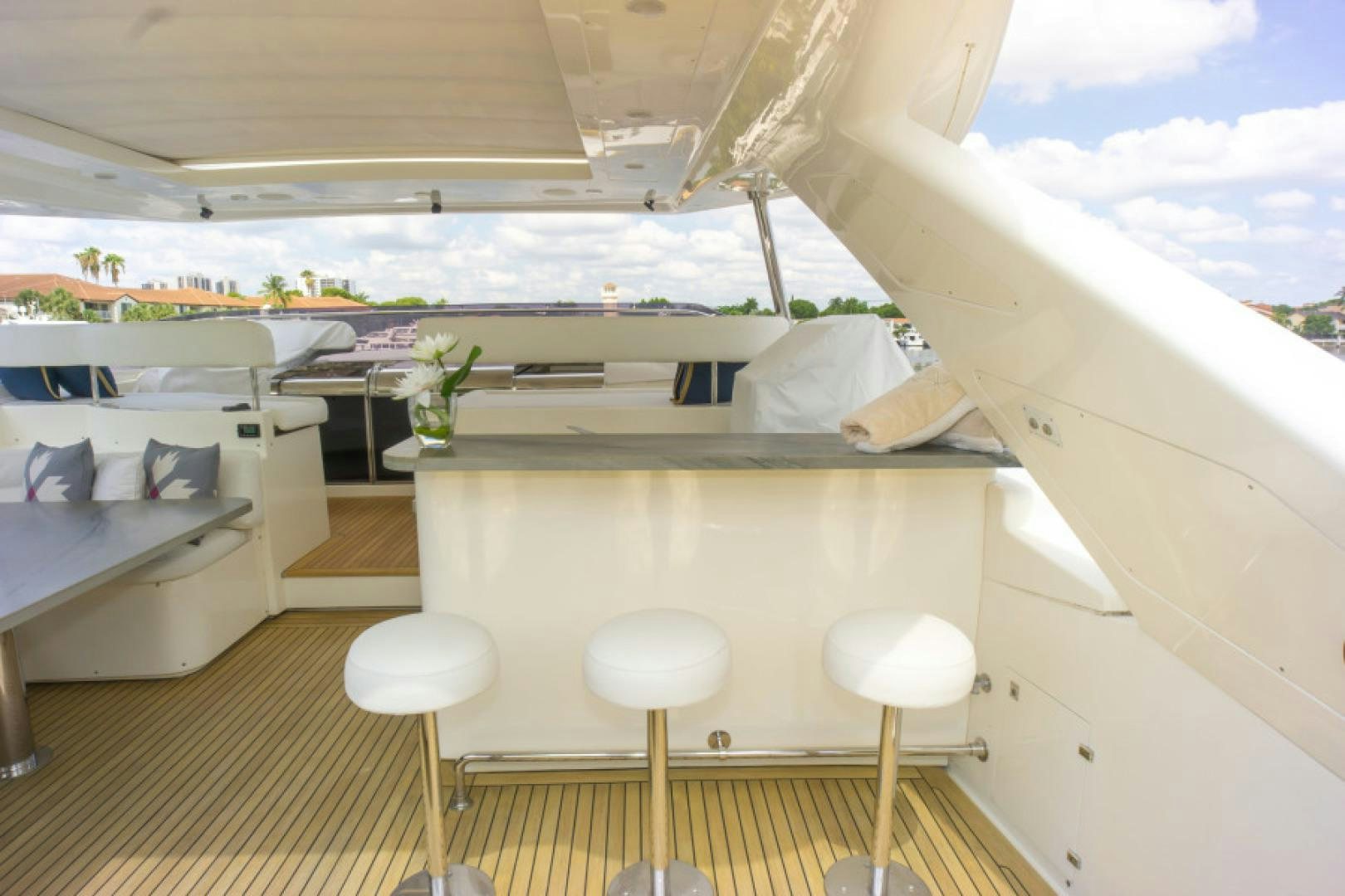 a room with a bed and stools and a table aboard ADAR Yacht for Sale