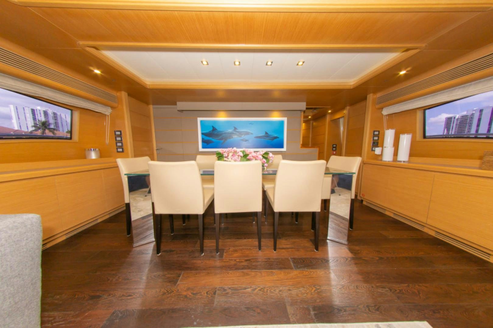 a room with tables and chairs aboard ADAR Yacht for Sale