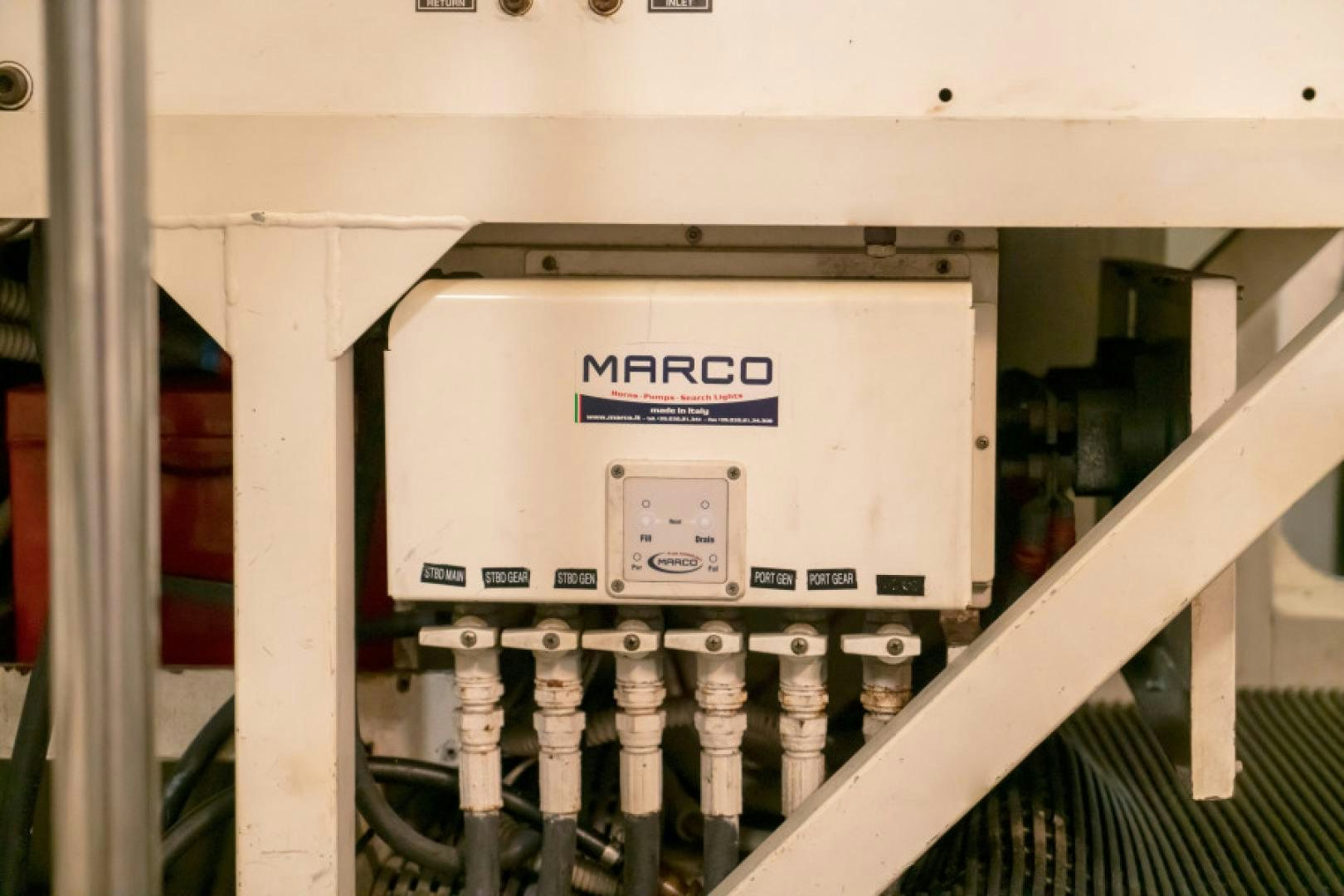 a white machine with a blue label aboard ADAR Yacht for Sale