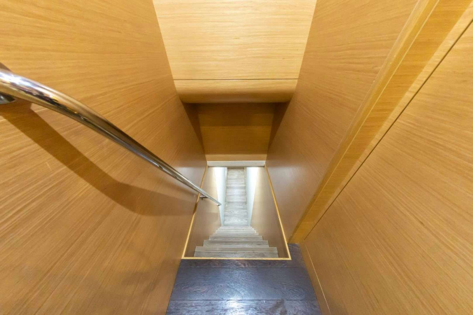 a wooden staircase with a railing aboard ADAR Yacht for Sale