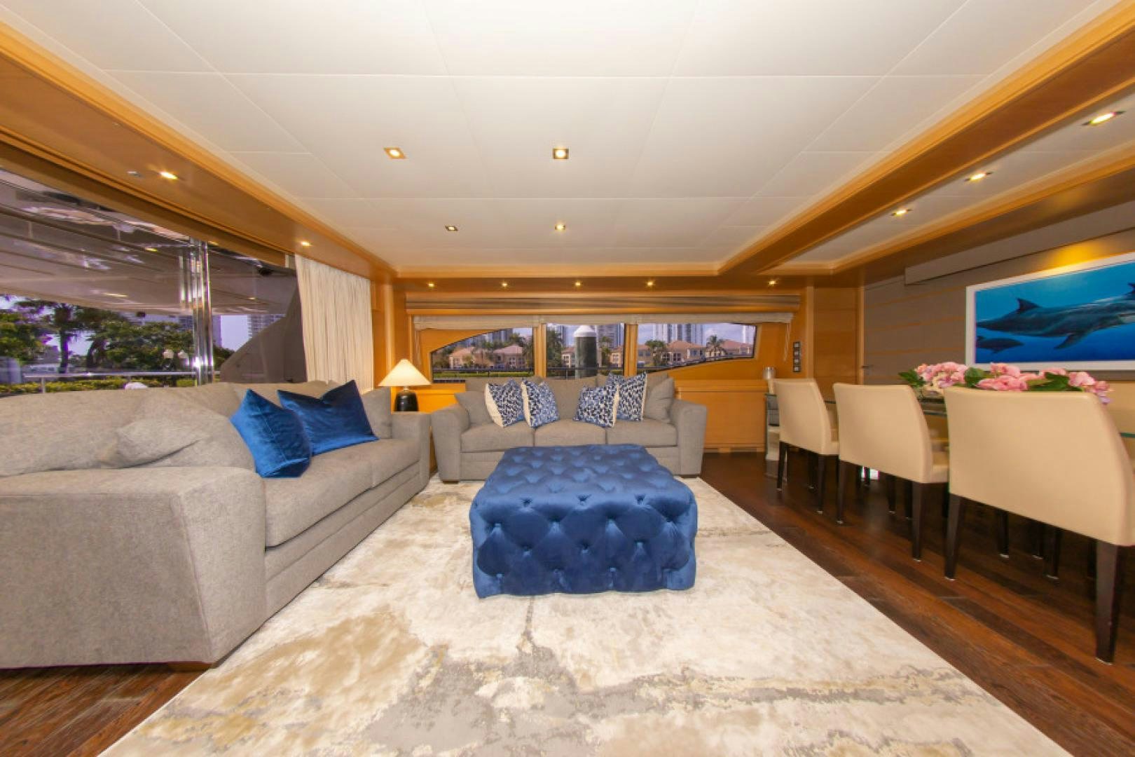 a living room with a couch and a large blue rug aboard ADAR Yacht for Sale