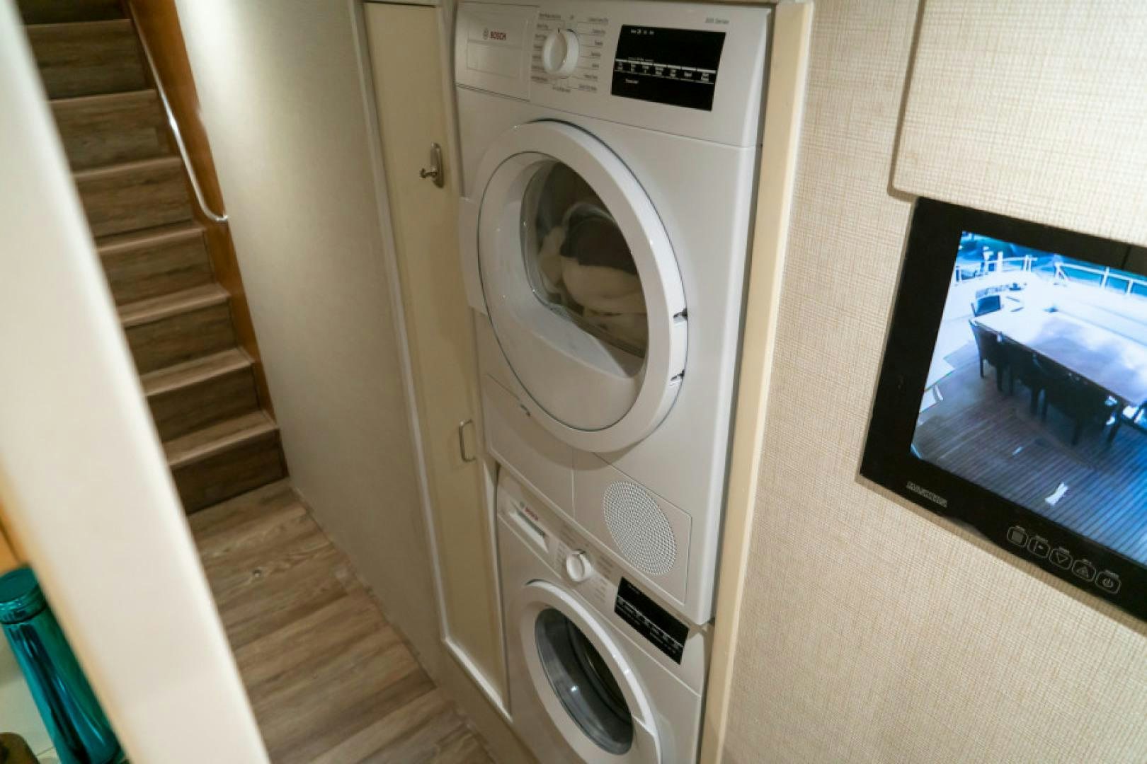 a white machine next to a television aboard ADAR Yacht for Sale