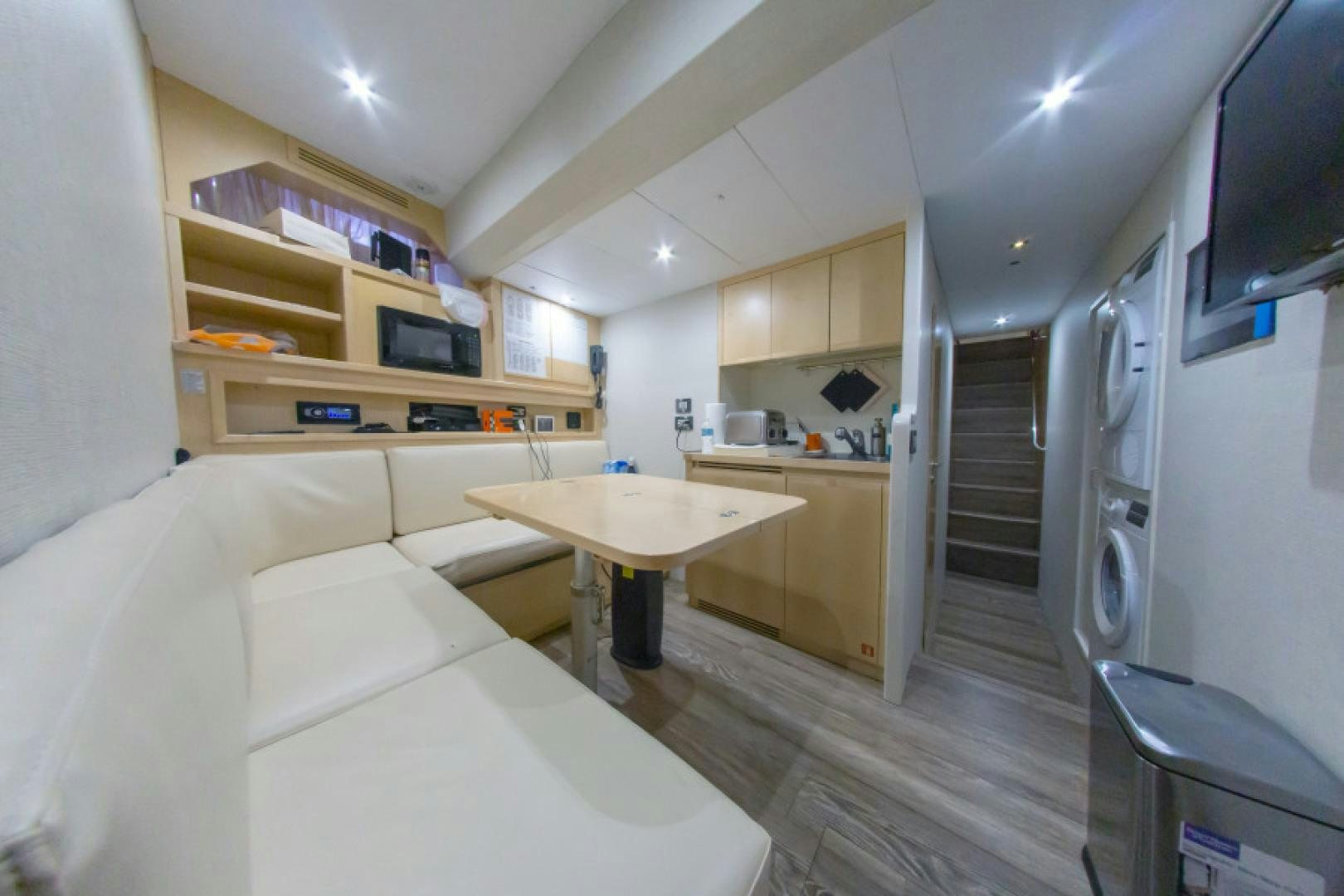a bedroom with a bed and a desk aboard ADAR Yacht for Sale