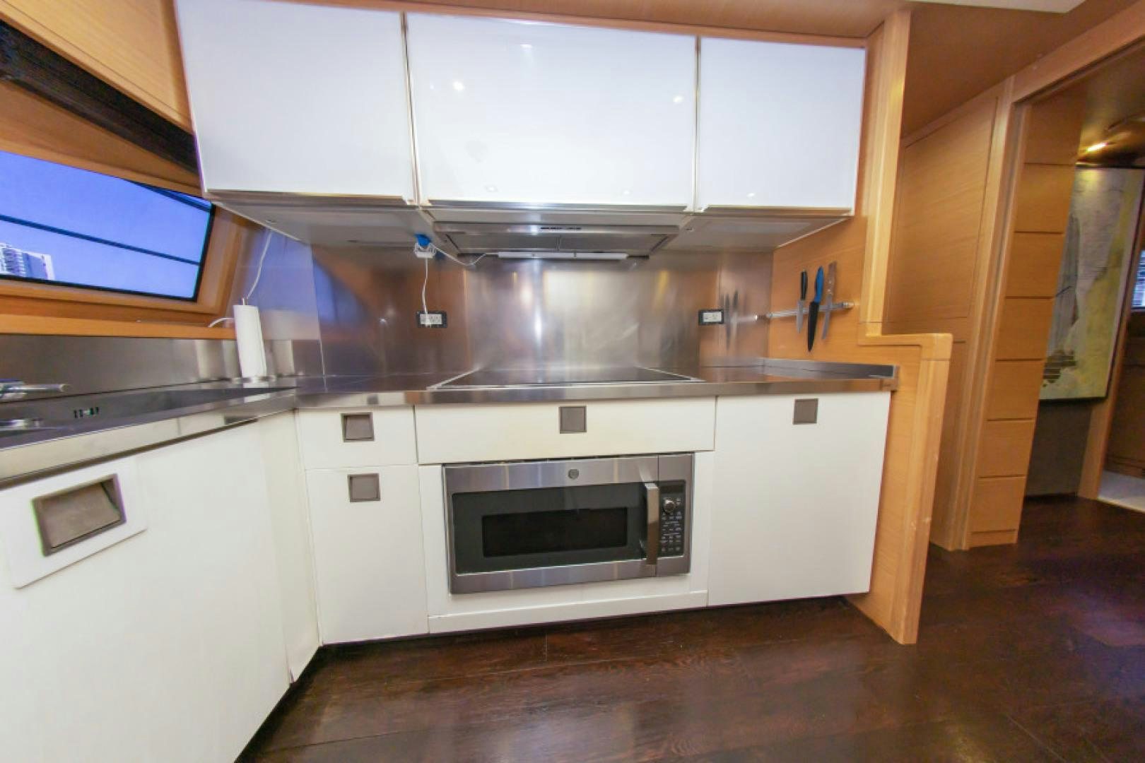 a kitchen with white cabinets aboard ADAR Yacht for Sale