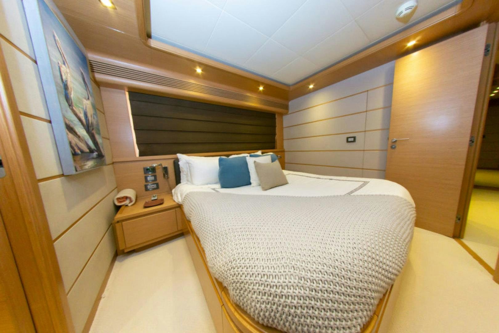 a room with a bed and a dresser aboard ADAR Yacht for Sale