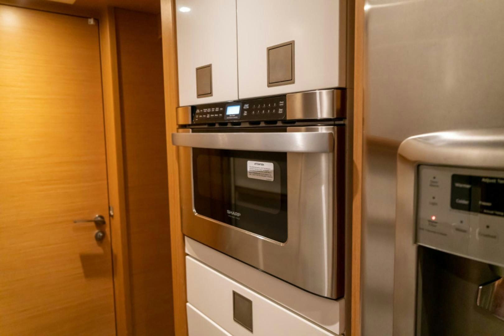 a kitchen with white cabinets aboard ADAR Yacht for Sale