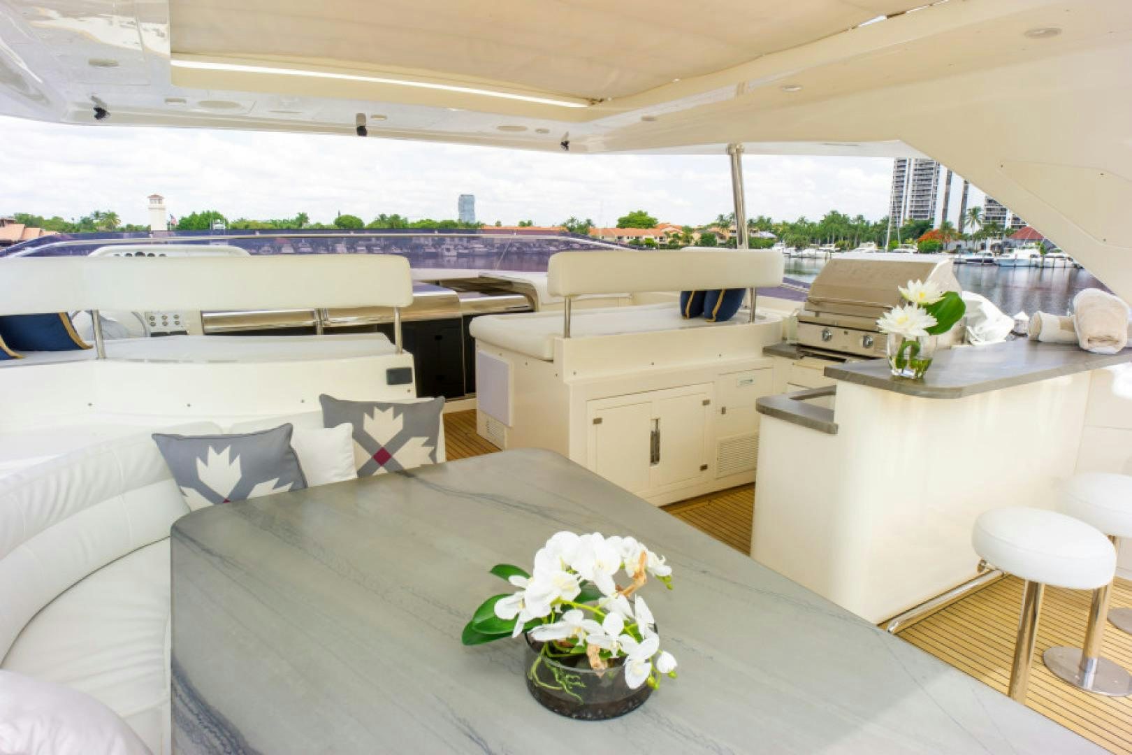 a room with a large white table and white couches aboard ADAR Yacht for Sale