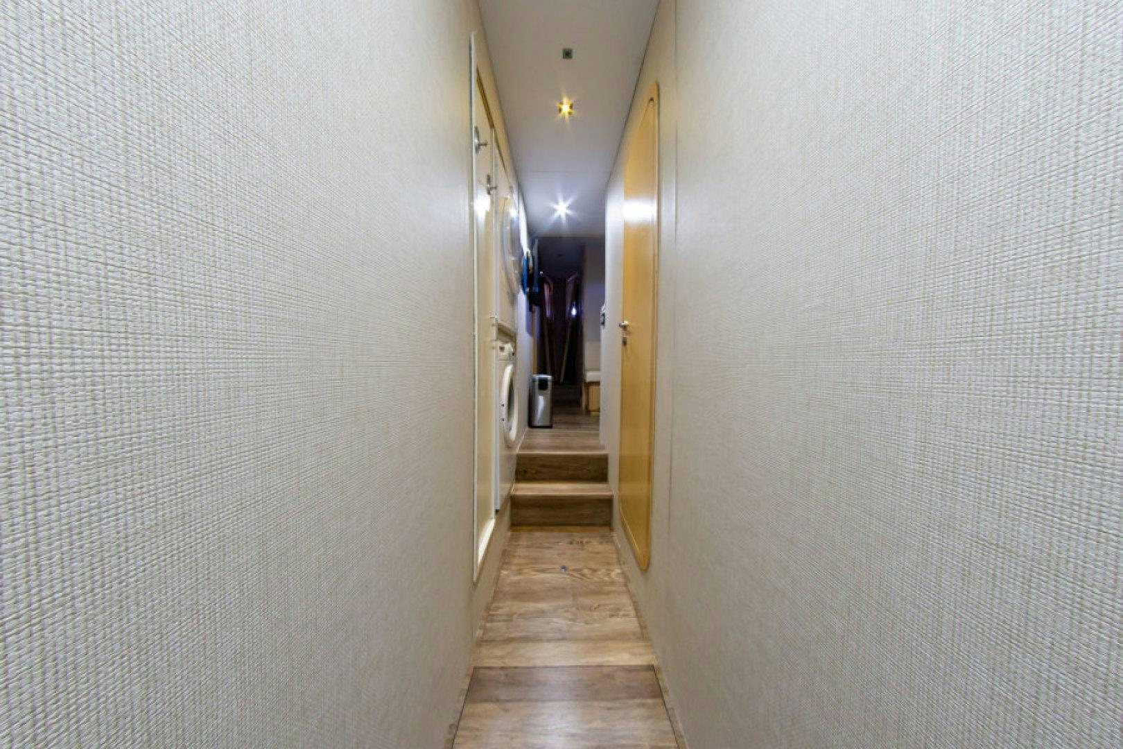 a hallway with white walls aboard ADAR Yacht for Sale