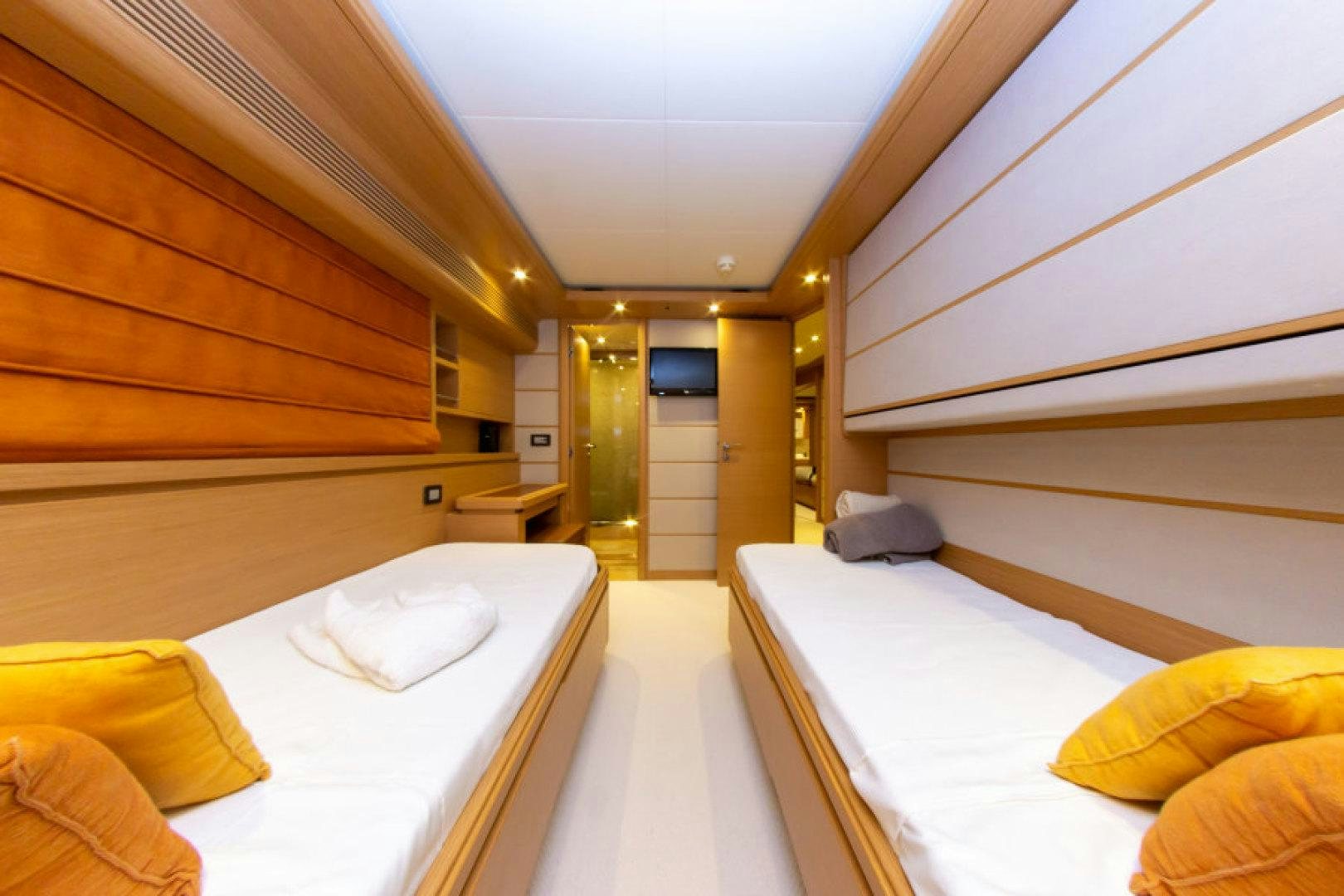 a room with a bed and a mirror aboard ADAR Yacht for Sale