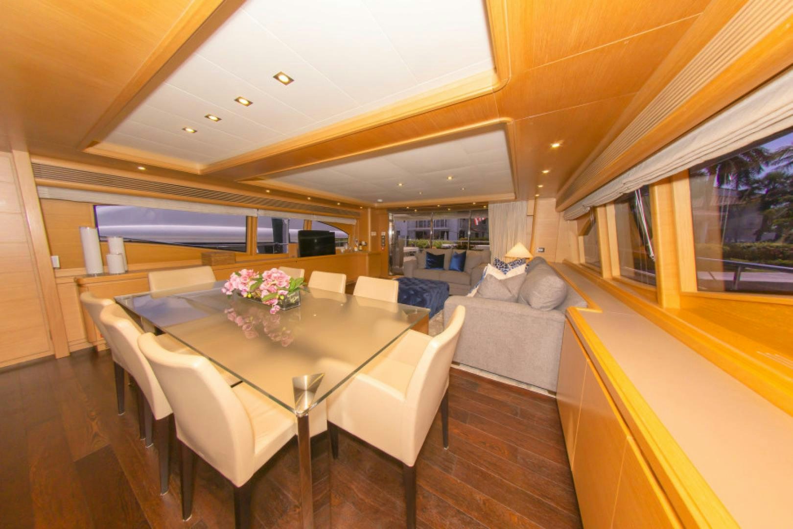 a large living room with a table and chairs aboard ADAR Yacht for Sale