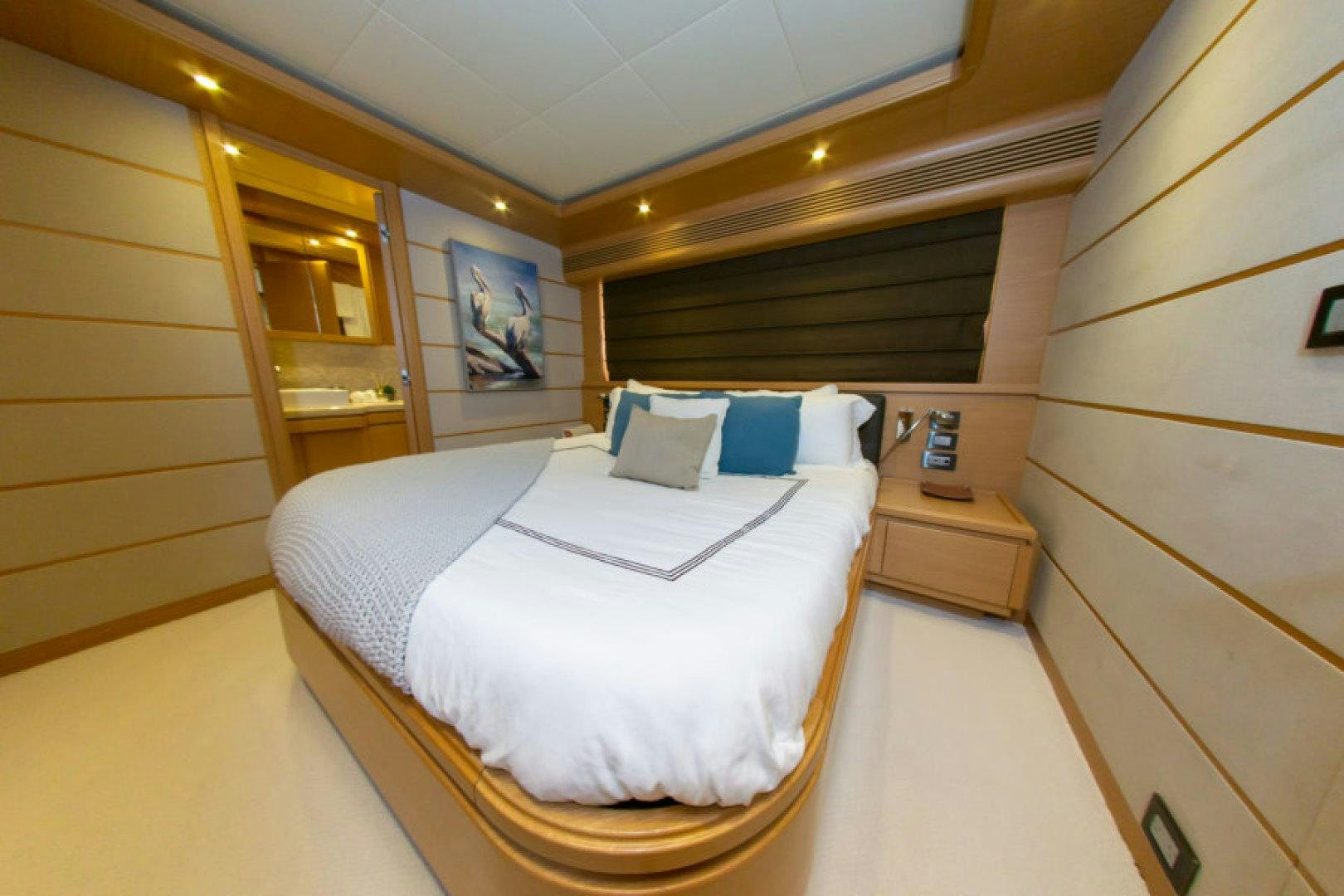 a bedroom with a bed aboard ADAR Yacht for Sale